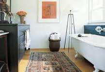 Bathroom rug infront of bath tub